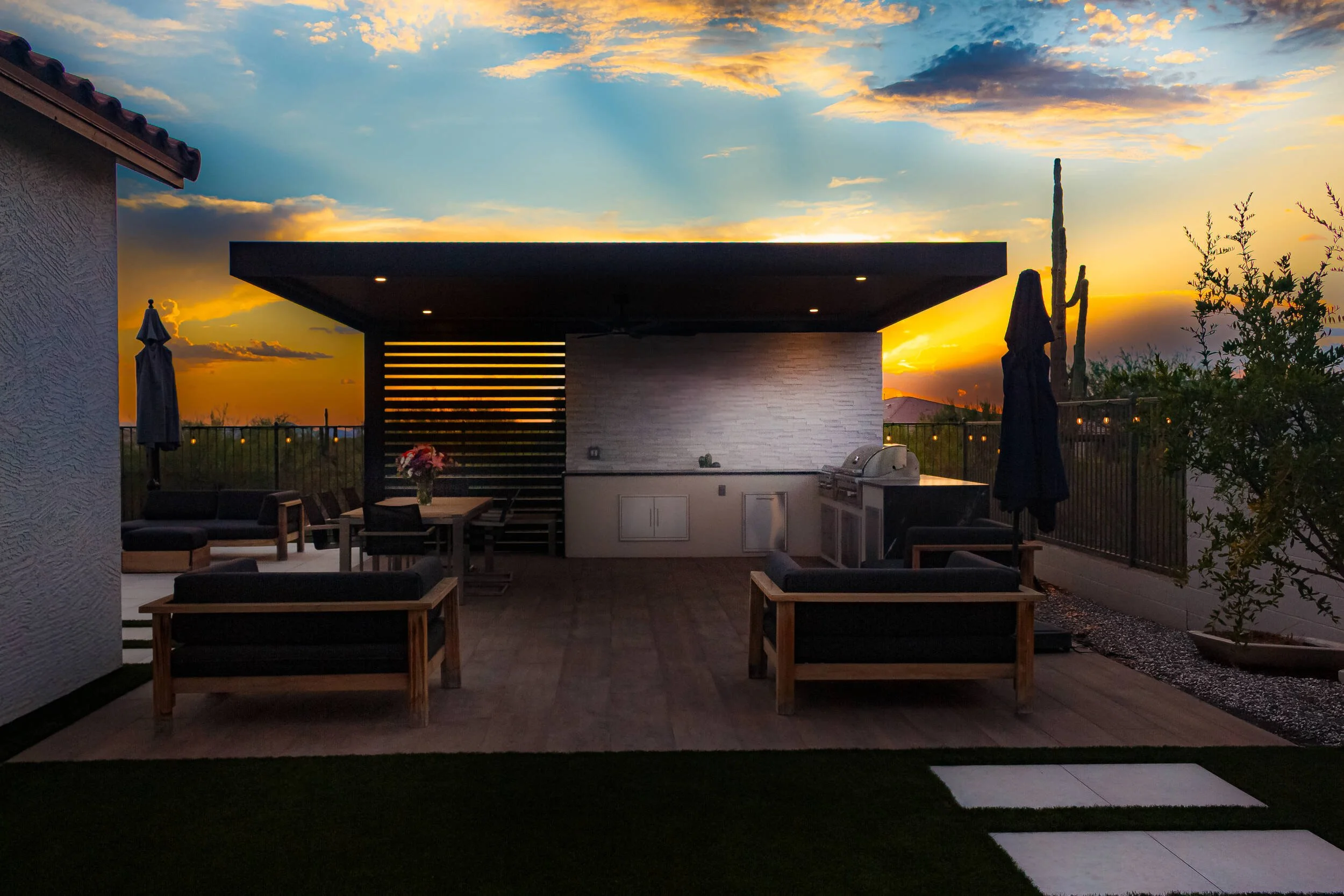 A backyard dining and pool area in Paradise Valley, AZ with outdoor lighting and landscape design