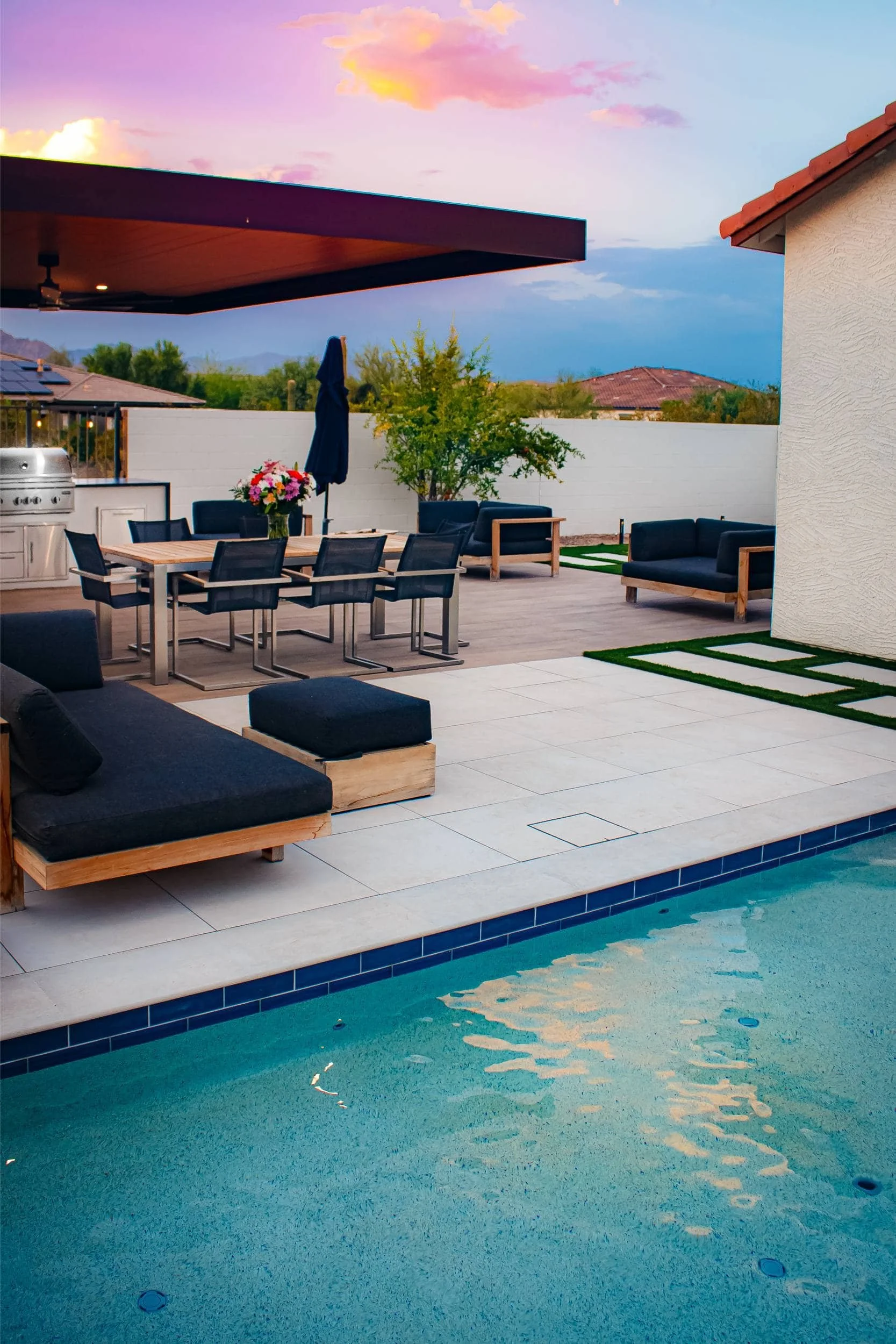 A shaded sitting area in Paradise Valley, AZ with pergola elements and modern outdoor lighting