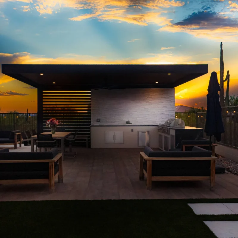 A backyard dining and pool area in Paradise Valley, AZ with outdoor lighting and landscape design