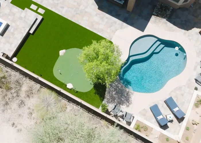 A large backyard transformation in Scottsdale, AZ showing landscape design around a freeform pool